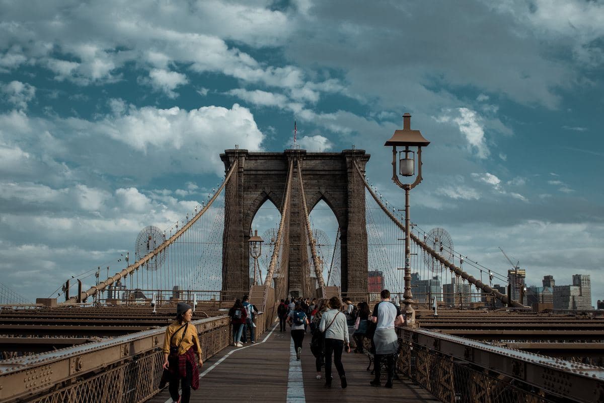 People walking across the Brooklyn Bridge in New York